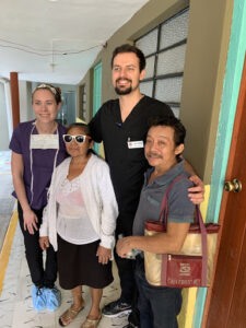 team members with happy patient