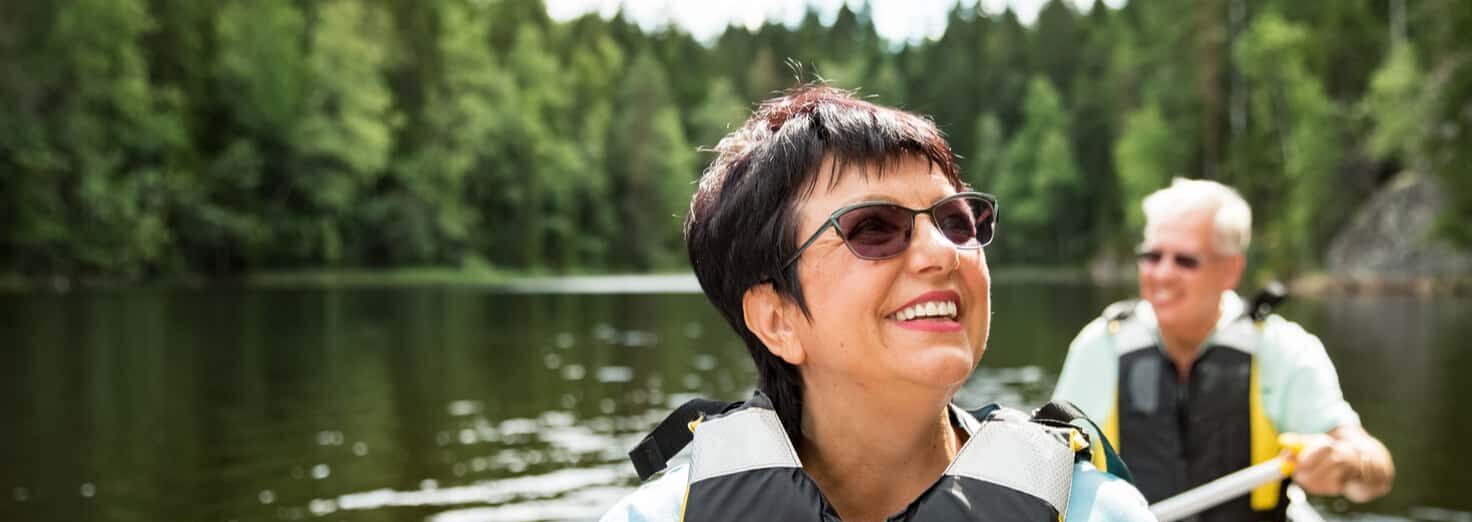 senior couple kayaking with restored vision from intraocular lens surgery