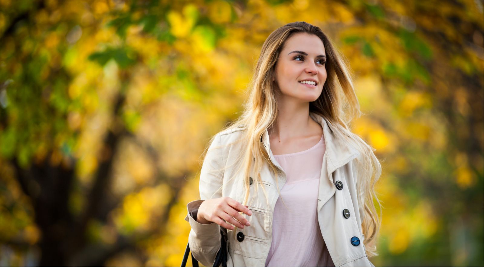happy woman walking through a park
