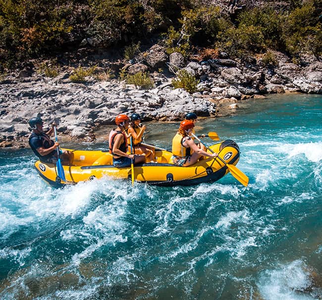 group of people white water rafting