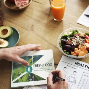 Healthy food on the table and a man planning out his meals