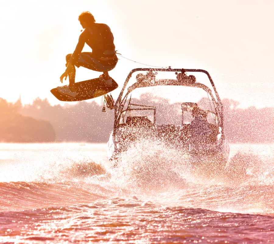 Guy doing a sick jump on a wakeboard