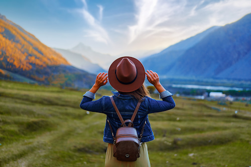 young woman looking towards beautiful horizon